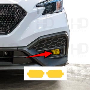 May include: A white car front bumper featuring a black honeycomb grille and a yellow fog light lens. A red arrow points to the fog light. Below the bumper, two yellow rectangular adhesive film overlays with rounded edges are displayed on a white background.