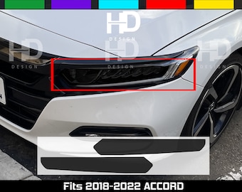 May include: Black headlight covers and a white car's front end are shown in this image. The text "HD DESIGN" is visible. The bottom of the image shows two black accessories and the text "Fits 2018-2022 ACCORD".
