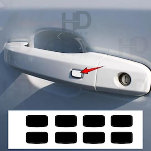May include: A white car door handle with a silver button and a keyhole. A red arrow points to the button. Below the handle are eight black rectangular stickers. The letters "HD DESIGN" are visible in the background.