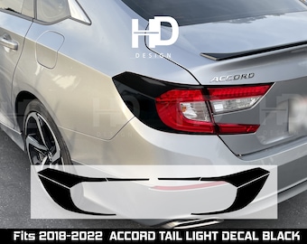May include: Black vinyl decal for the tail lights of a silver Honda Accord. The decal is shaped like a curved line and says "ACCORD" in the image.  Fits 2018-2022 Accord Tail Light Decal Black.