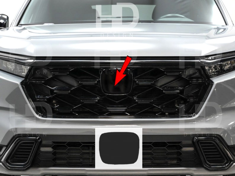May include: A silver car with a black grille and a black Honda emblem. The car has a black license plate cover.