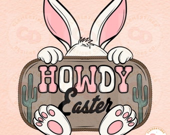 Peut inclure: Un lapin blanc qui regarde par-dessus une pancarte en bois rustique avec le texte "Howdy Easter" en lettres roses. La pancarte est décorée d'une bordure en corde et de deux cactus verts.