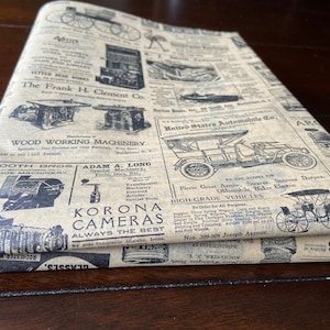 May include: A vintage style brown paper with black text and images. The paper features advertisements for various products, including wood working machinery, cameras, and automobiles. The text includes the names of companies such as "Booth Bros", "Adam A. Long", "Korona Cameras", and "United States Automobile Co.".