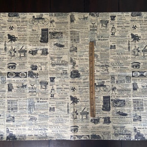 May include: A vintage style wrapping paper with a repeating pattern of black and white newspaper clippings. The paper features various advertisements and articles from the early 1900s, including ads for coal, the "Power Washer", and "Archer Mfg Co.".