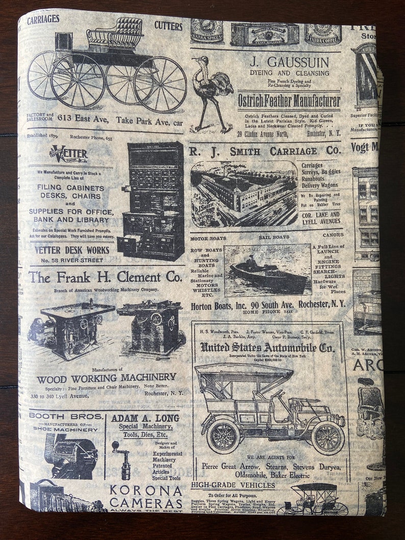 May include: A vintage newspaper clipping with advertisements for various businesses, including carriage makers, boat builders, wood working machinery, shoe machinery, cameras, and automobiles. The newspaper is printed on brown paper with black ink.