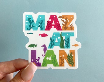 May include: A colorful sticker with the word "Mazatlan" written in a stylized font. The letters are decorated with sea life, including fish, seaweed, and a seahorse.
