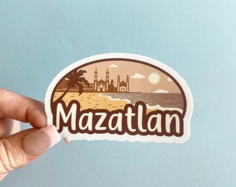 May include: A white sticker with a brown illustration of a beach scene with buildings, palm trees, and the text "Mazatlan".