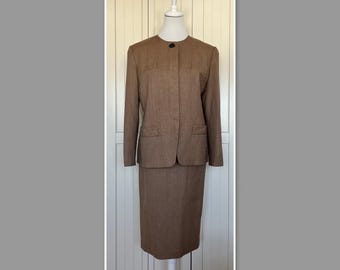 May include: A brown skirt suit with a single button closure and a straight skirt. The suit is made of a textured fabric.