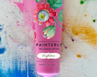 May include: A pink tube of "Confection" blendable furniture paint, 118 ml, with floral illustrations. The tube is labeled "PAINTERLY" and "The Language of Color". The background features colorful paint splatters.