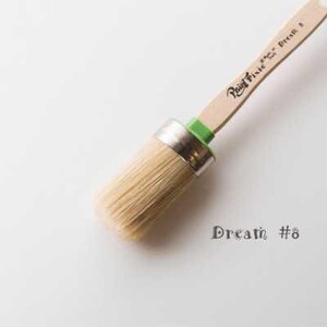 May include: A close-up of a round paint brush with a wooden handle and a green ferrule. The handle is labeled "Rainy Day" and the brush is labeled "Dream #8".