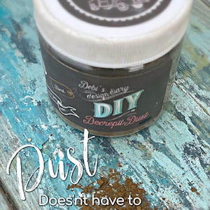 May include: A jar of Debi's Diary DIY Decrepit Dust with a white lid and a black label. The label features the text "DIY Decrepit Dust" and a vintage truck illustration. The words "Dust Doesn't have to be a chore" are also visible.