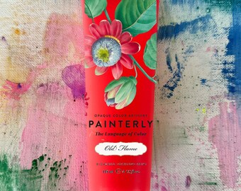 May include: A tube of "Old Flame" oil paint from the brand "Painterly". The red tube features a floral design with green leaves and a red flower. The text "The Language of Color" is also visible.