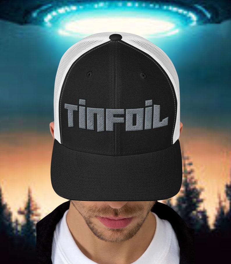 May include: A black and white trucker hat with a grey embroidered logo that says "Tinfoil".