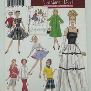 May include: Simplicity Fashion Doll sewing pattern with illustrations of doll clothing designs. The pattern includes dresses, skirts, and coats. The package is labelled "5785" and includes the text "One Size".