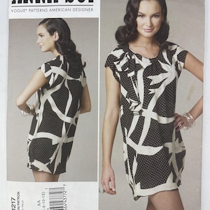 May include: Vogue Patterns American Designer Anna Sui sewing pattern V1217. The pattern features a black and white dress with a unique abstract design. The pattern includes sizes AA (6-8-10-12).