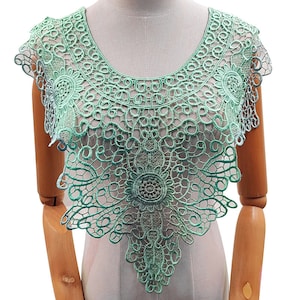 May include: A delicate green lace collar with a scalloped edge and intricate floral designs. The lace is lightweight and airy, perfect for adding a touch of elegance to any garment.