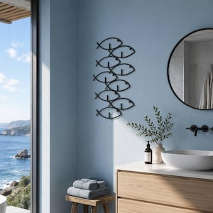May include: A black metal wall art piece featuring a vertical arrangement of stylized fish outlines. The design consists of multiple interconnected fish shapes stacked in a column, creating a cohesive decorative element for a wall surface.