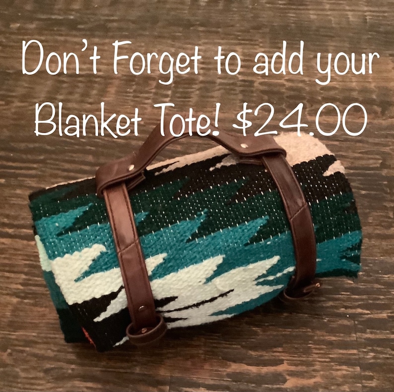 May include: A rolled-up blanket tote with brown leather handles and straps. The blanket has a turquoise, white, black, and beige geometric pattern. The text on the image says, "Don't Forget to add your Blanket Tote!"