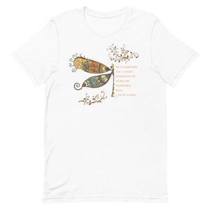 May include: White t-shirt with a brown and green dragonfly design and the text "They whispered you cannot withstand the storm. She whispered back, I am the storm."