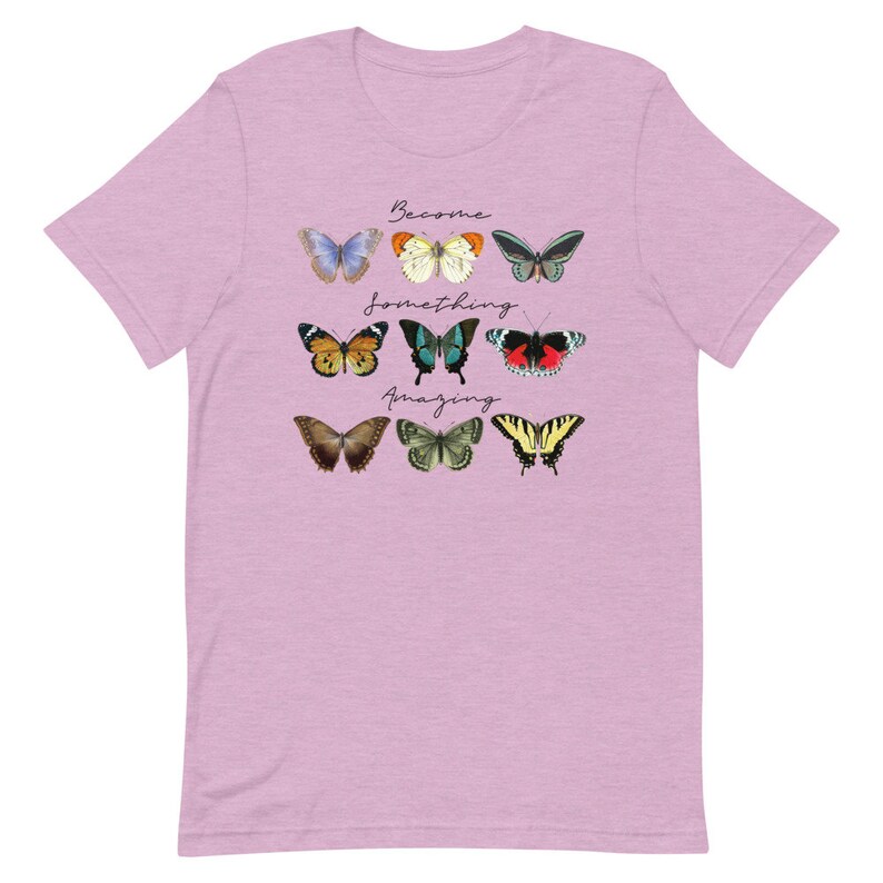 May include: A light pink t-shirt with a graphic of colorful butterflies and the text "Become something amazing".