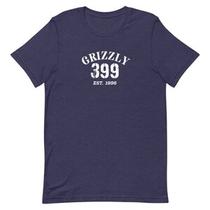May include: A navy blue t-shirt with a white distressed graphic that says "Grizzly 399 Est. 1996".