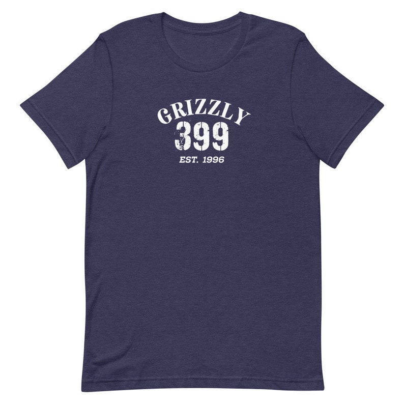 May include: A navy blue t-shirt with a white distressed graphic that says "Grizzly 399 Est. 1996".