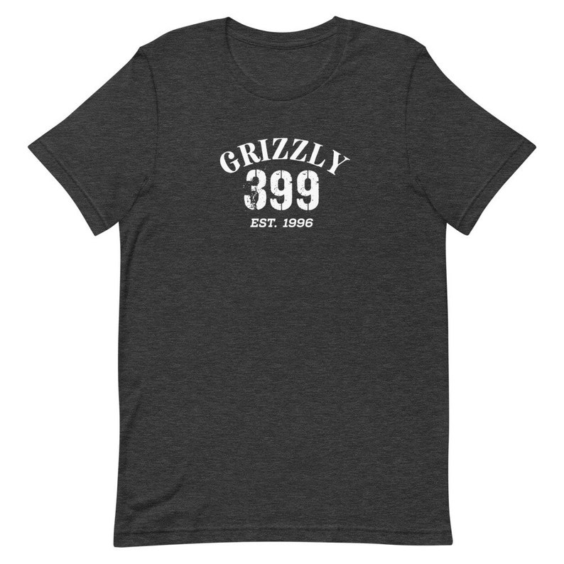 May include: Dark heather grey t-shirt with a white graphic print that says "Grizzly 399 Est. 1996".