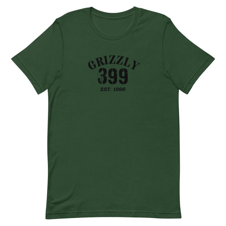 May include: A green short-sleeved t-shirt with a black graphic print that says "Grizzly 399 Est. 1996".