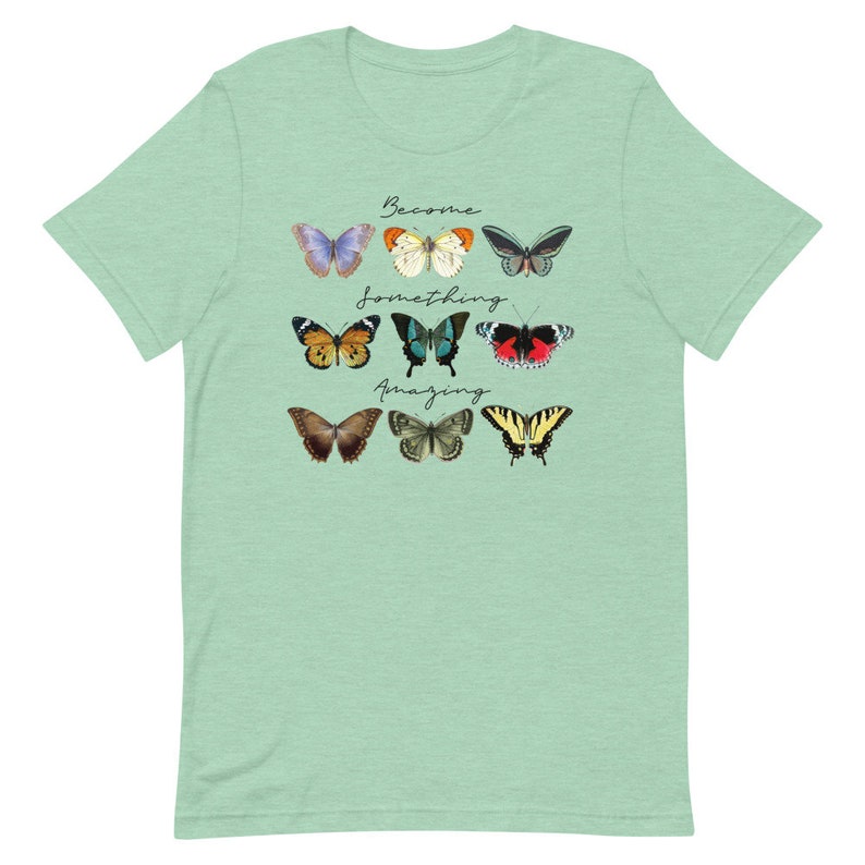 May include: A light green t-shirt with a design of colorful butterflies and the text "Become something amazing".