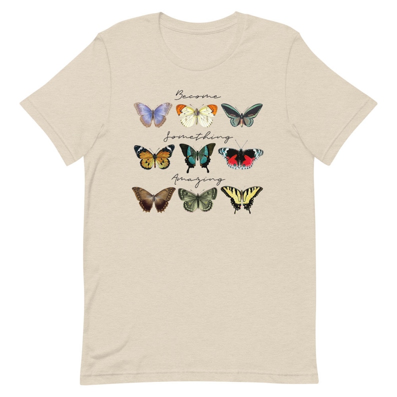 May include: A beige t-shirt with a graphic of colorful butterflies and the text "Become something amazing".