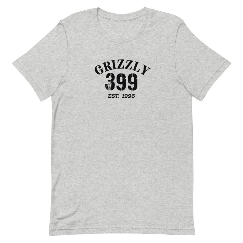May include: A heather grey t-shirt with a black graphic print of "Grizzly 399 Est. 1996".