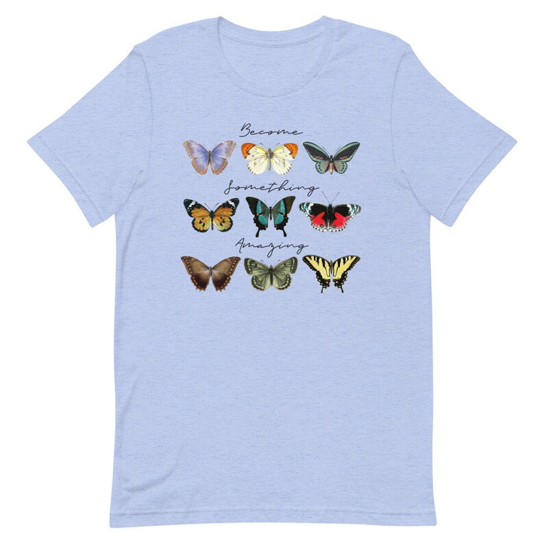 May include: Light blue t-shirt with a design of colorful butterflies and the text "Become something amazing".