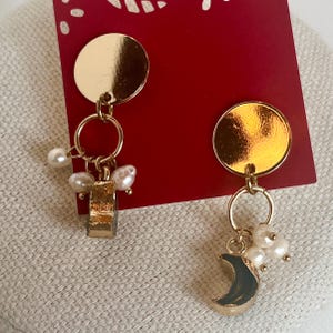 Gold hued dangle and drop celestial sun moon and stars stud earrings