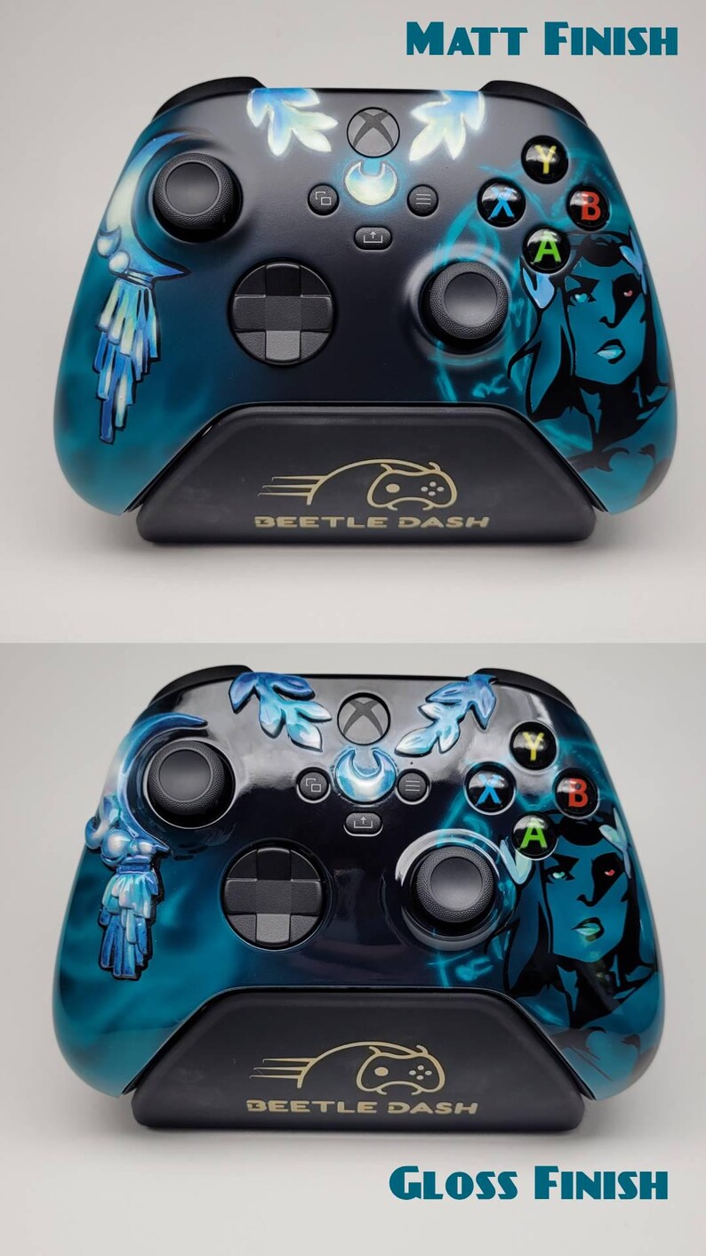 May include: Custom Xbox controller with a blue and black design. The controller features a matte finish and a stylized illustration of a woman's face on the right side. The controller rests on a black stand with the text "BEETLE DASH".