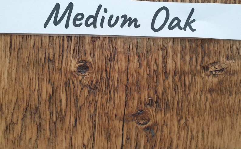 May include: Close-up of a wood grain texture with a medium oak finish. The wood has a natural brown color with knots and grain patterns.