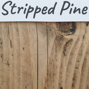 May include: Stripped Pine wood panel with a natural wood grain and knots. The wood has a light brown color with darker brown knots.