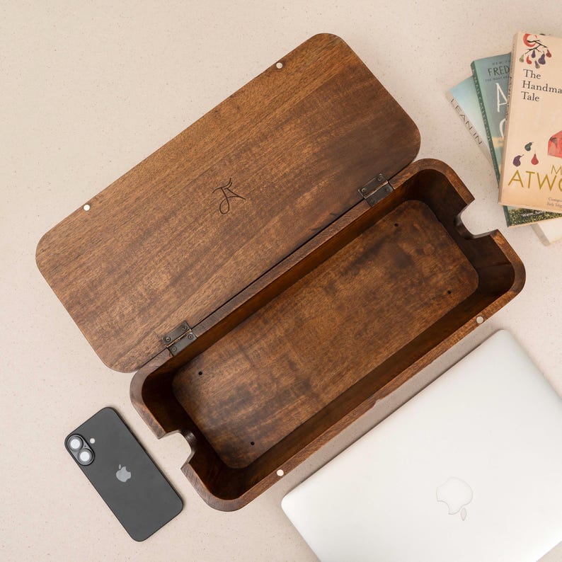 a wooden box with a laptop and a smartphone placed on top of it.
