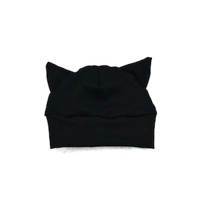 May include: Black cat ear beanie hat. The hat is made of a soft, stretchy fabric.