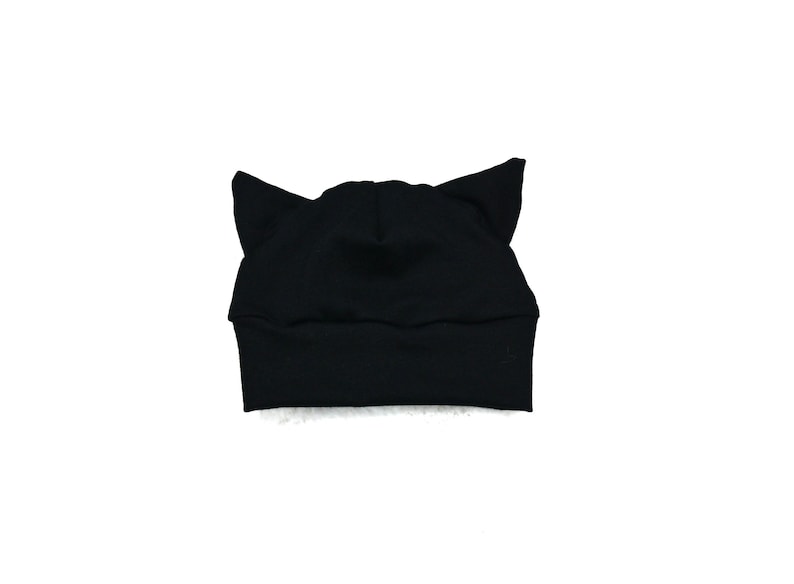 May include: Black cat ear beanie hat. The hat is made of a soft, stretchy fabric.