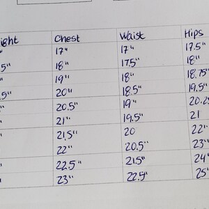 May include: A chart showing clothing sizes for children from 0-3 months to 5-6 years. The chart includes measurements for height, chest, waist, hips, and head in inches.