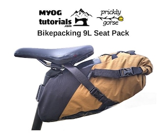 May include: A brown and black bikepacking seat pack with a 9L capacity. The pack is attached to a bike seat post with straps and buckles. The pack is made by MYOG tutorials.