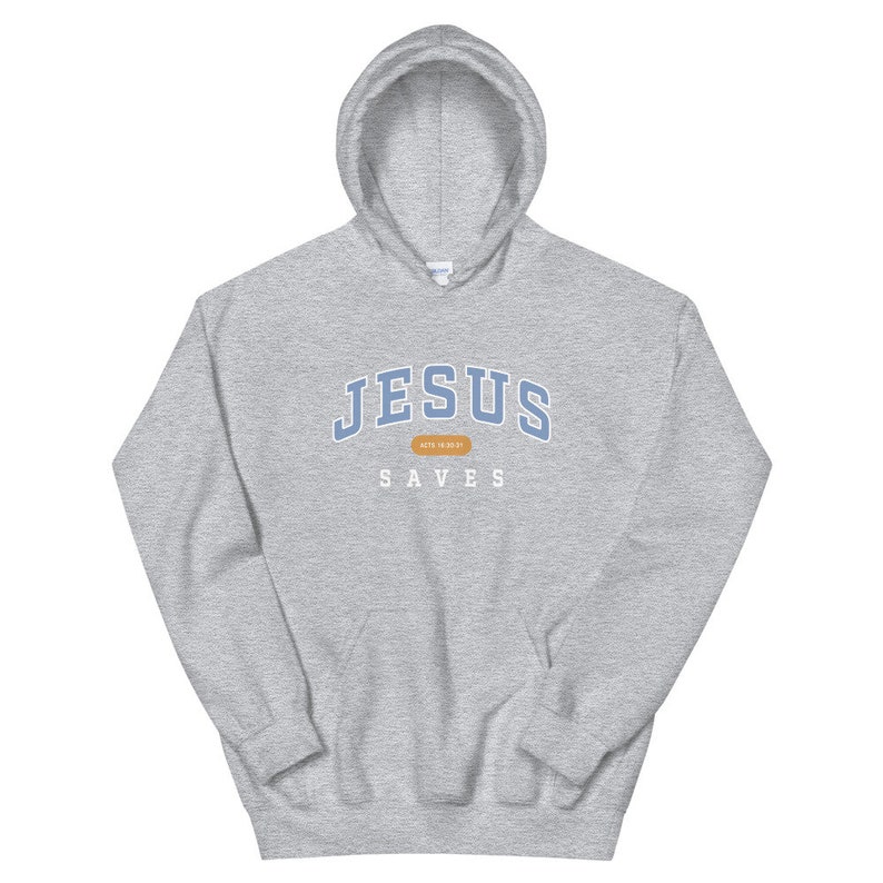 May include: A gray hooded sweatshirt with the text "JESUS SAVES" in blue and white lettering. The text "ACTS 16:30-31" is in a small brown rectangle.