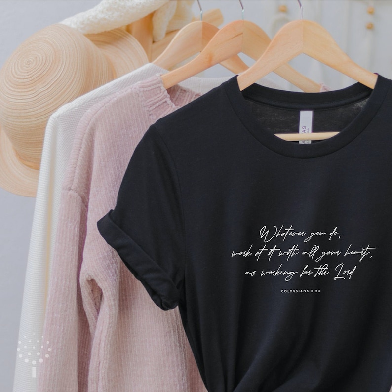 May include: Black t-shirt with white text that reads "Whatever you do, work at it with all your heart, as working for the Lord. Colossians 3:23"
