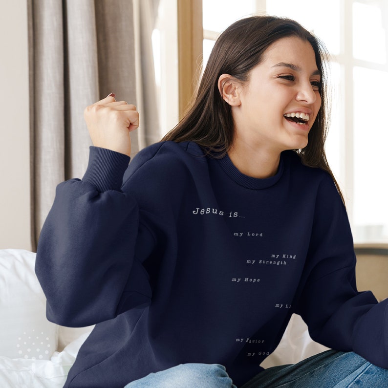 May include: A navy blue sweatshirt with the text "Jesus is... my Lord, my King, my Strength, my Hope, my Savior, my God, my Life" printed in white.