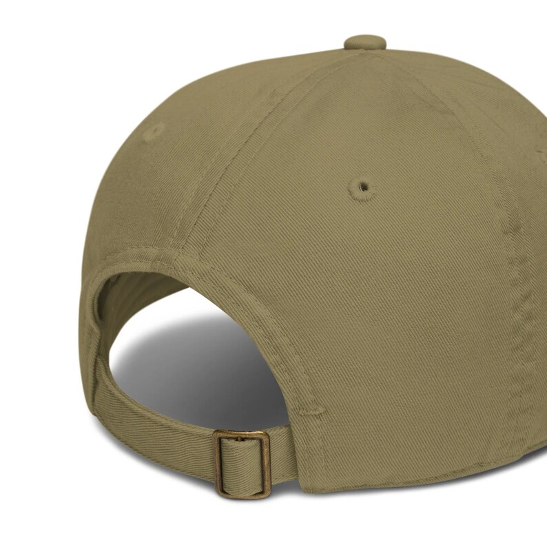 May include: A khaki colored baseball cap with a brown adjustable strap and buckle.