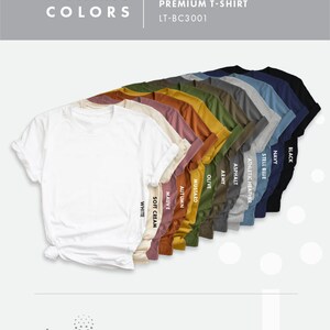 May include: A selection of unisex t-shirts in various colors, including white, soft cream, mauve, autumn, mustard, olive, army, asphalt, athletic heather, steel blue, navy, and black. The t-shirts are arranged in a row, with the white t-shirt at the front and the black t-shirt at the back. The text "T-SHIRTS COLORS" is at the top of the image, and the text "UNISEX PREMIUM T-SHIRT LT-BC3001" is at the top right of the image.