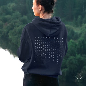 May include: A navy blue hoodie with a white word search puzzle on the back. The puzzle features the text "ISAIAH 43:2" and includes the words "love", "faith", "strength", "hope", and "joy".