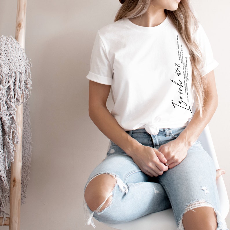 May include: White t-shirt with a black vertical graphic that says "I rejoice" and a Bible verse, "1 Thessalonians 5:16-18".