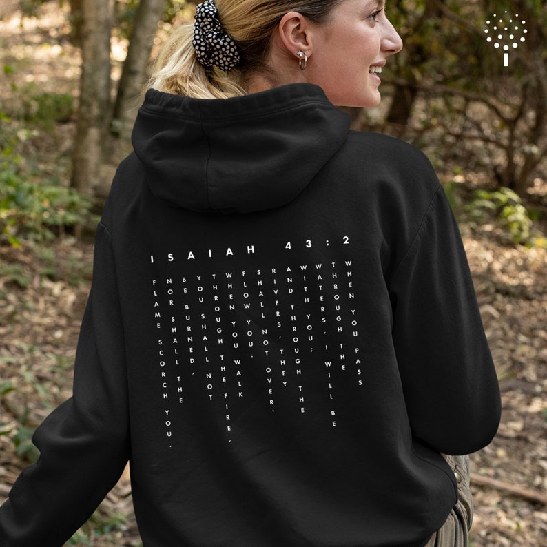 May include: Black hooded sweatshirt with white text on the back that reads "ISAIAH 43:2" and a word search puzzle with the words "FOR BY THE WATERS OF BABYLON WE SAT DOWN AND WEPT WHEN WE REMEMBERED ZION."
