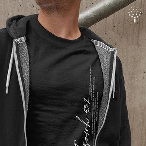 May include: Black t-shirt with a white graphic print of the text "Soich 43:2" and a bible verse quote. The quote reads "When you pass through the waters, I will be with you. When you walk through the fire, you will not be burned. And when you pass through the rivers, they will not sweep over you. The flames will not set you ablaze."